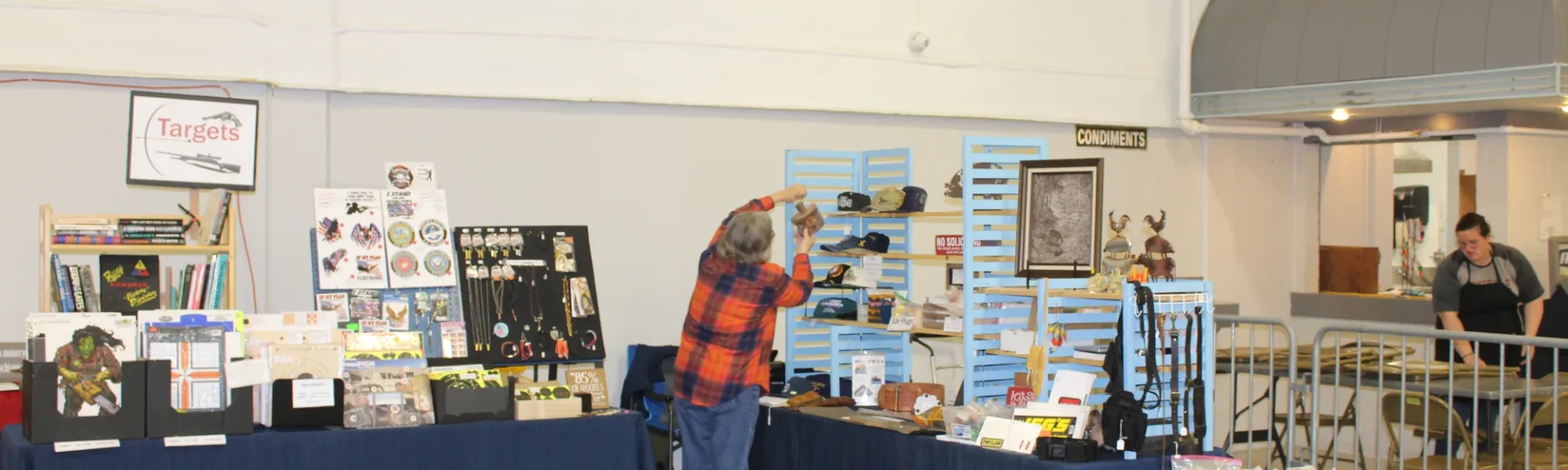 Vendor booth with collectibles and sporting goods at a gun show