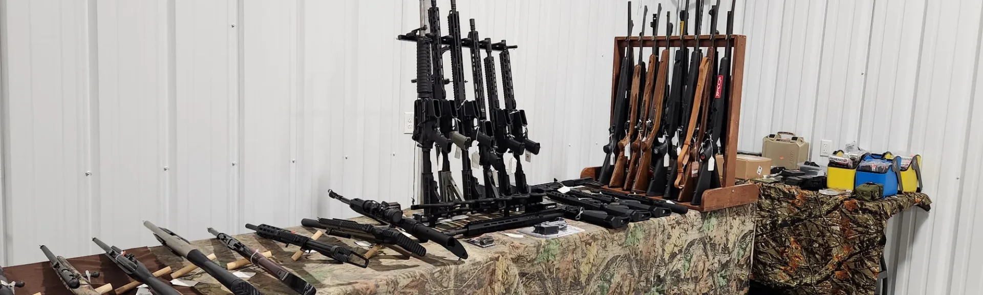 Rifles and shotguns racked on a vendor table at an Idaho gun show
